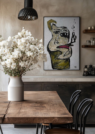 Pipan by RR in a black frame above a rustic table with white flowers
