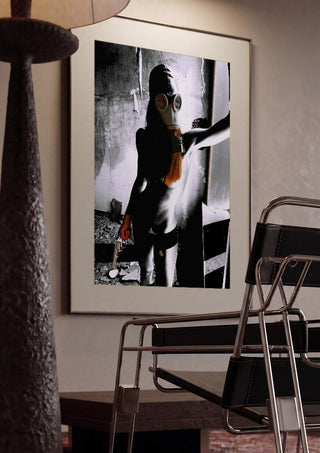 Beauty The Beast by Pelecan Schneider framed in a dim room beside a tubular steel chair
