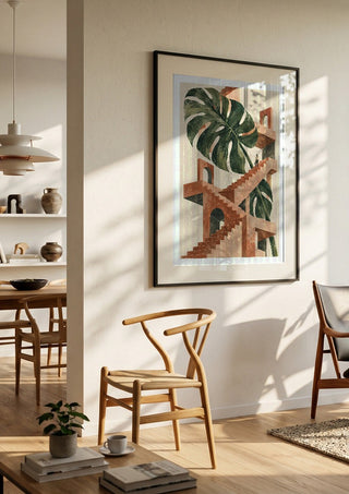 The Green Staircase by Matthews Gallerie in a black frame in a bright dining room with wooden chairs