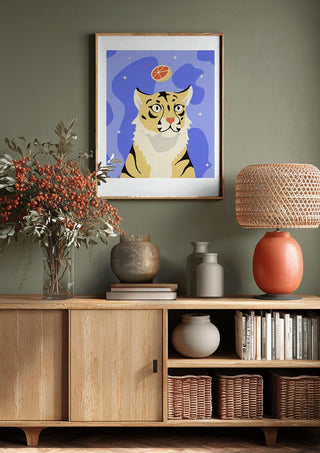 Grrrapefruit by Jakob Falkenberg above a wooden sideboard on a sage green wall