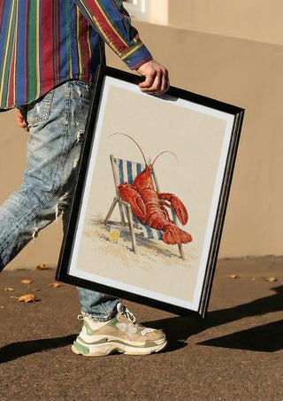 The Lobster’s Day Off by Matthews Gallerie carried in a black frame along a sunny street