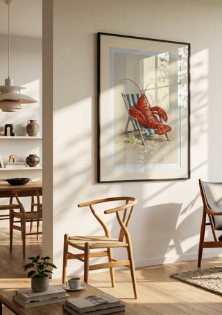 The Lobster’s Day Off by Matthews Gallerie in a black frame in a bright dining room with wooden chairs