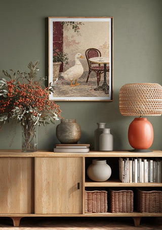 The Duck Wore Pearls by Matthews Gallerie above a wooden sideboard on a sage green wall