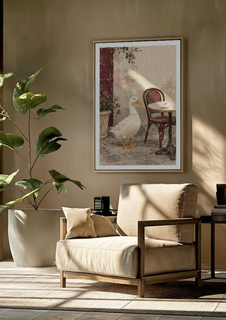 The Duck Wore Pearls by Matthews Gallerie framed above a beige armchair beside a potted plant