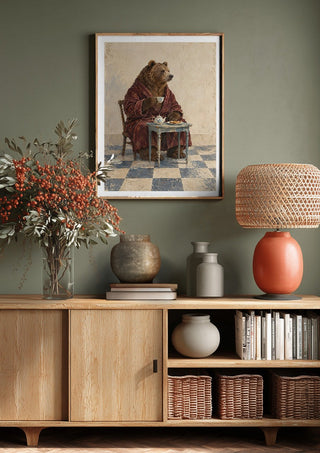 Tea Before Noon by Matthews Gallerie above a wooden sideboard on a sage green wall