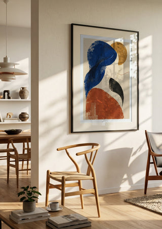 The Shape of Silence by Matthews Gallerie in a black frame in a bright dining room with wooden chairs