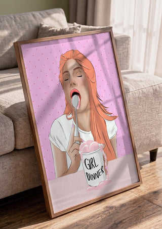 Girl Dinner by Lisen Vennesland in a walnut frame leaning against a grey sofa