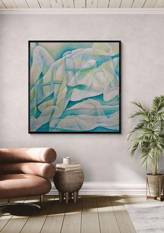 The Creation of the World by Andreas Pohle in a black frame above a tan leather chair beside a potted plant