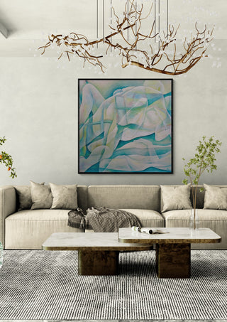 The Creation of the World by Andreas Pohle in a black frame above a beige sofa under a branch chandelier