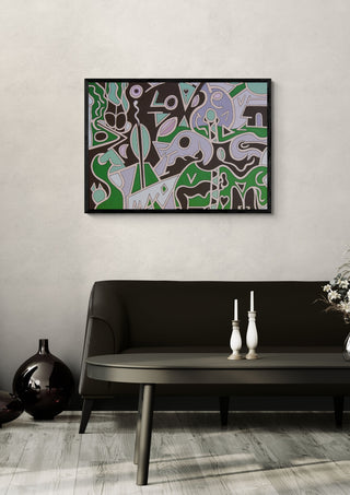 Love is All by Andreas Pohle in a black frame above a dark sofa with candlesticks and a vase