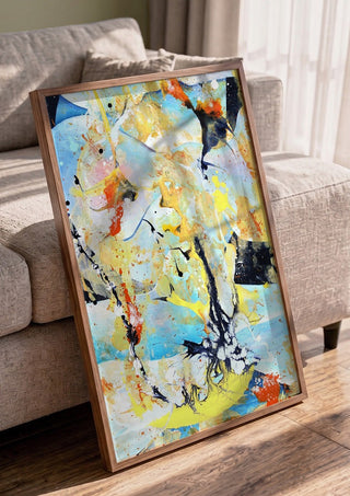 Composition Yellow on Blue by Andreas Pohle in a walnut frame leaning against a grey sofa