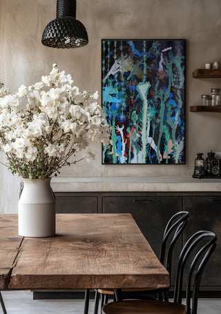 Mystical Garden by Andreas Pohle in a black frame above a rustic table with white flowers
