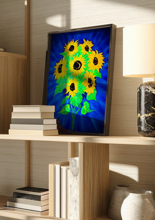 Sunflowers by Walter Zettl in a dark frame on a wooden shelf beside books and a lamp