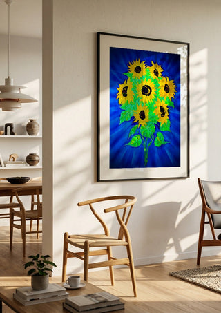 Sunflowers by Walter Zettl in a black frame in a bright dining room with wooden chairs