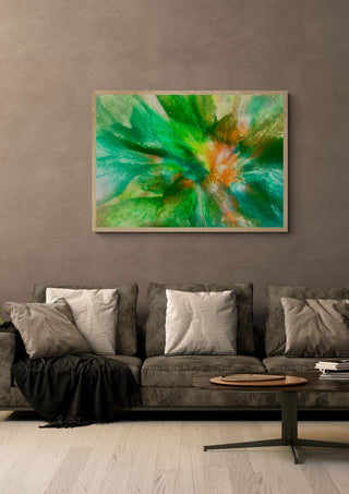 Emerald Burst by Da Winters in a light wood frame above a grey sofa with cushions