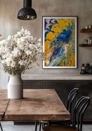 Gold and Indigo by Da Winters in a black frame above a rustic table with white flowers
