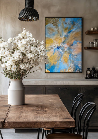 Sand and Sky by Da Winters in a black frame above a rustic table with white flowers