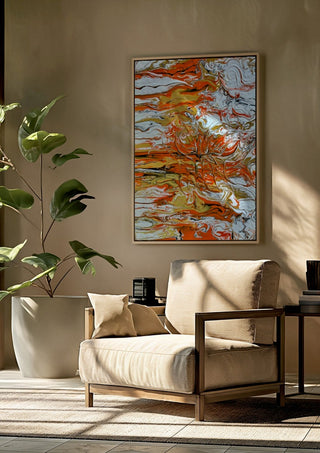 Orange Tide by Da Winters framed above a beige armchair beside a potted plant
