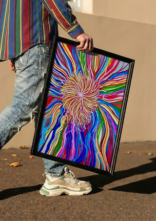 Rainbow Spin by Da Winters carried in a black frame along a sunny street