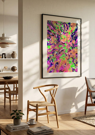 Neon Bloom by Da Winters in a black frame in a bright dining room with wooden chairs