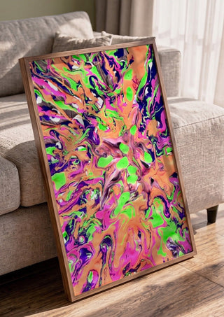 Neon Bloom by Da Winters in a walnut frame leaning against a grey sofa