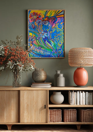 Garden Party by Da Winters above a wooden sideboard on a sage green wall