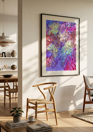 Petal Ridge by Da Winters in a black frame in a bright dining room with wooden chairs