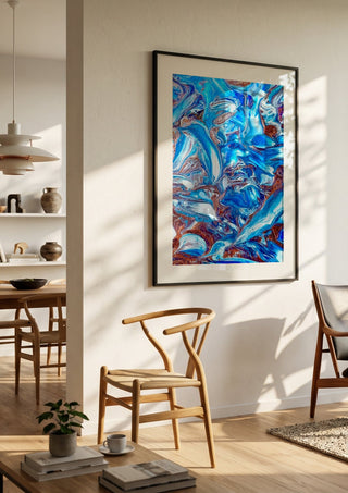 Blue Waves by Da Winters in a black frame in a bright dining room with wooden chairs