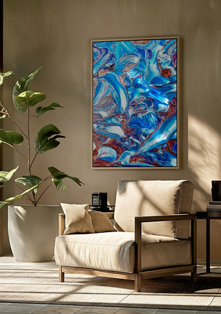 Blue Waves by Da Winters framed above a beige armchair beside a potted plant