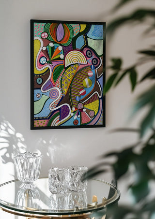 Peaceful Power by LGDyrby in a black frame above a glass table with crystal glassware