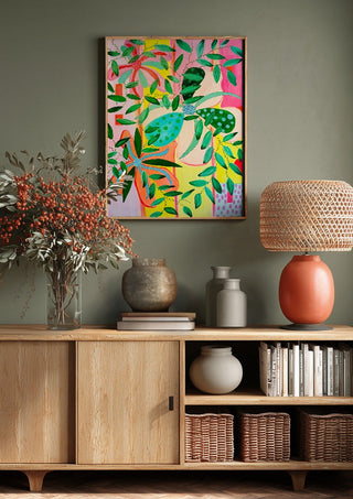 Bloom by LGDyrby above a wooden sideboard on a sage green wall