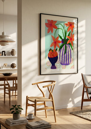 Plums & Peace by LGDyrby in a black frame in a bright dining room with wooden chairs