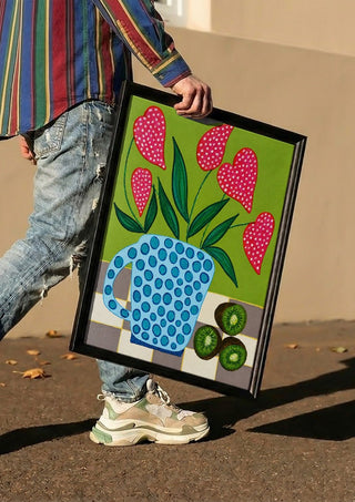 Kiwi My Heart by LGDyrby carried in a black frame along a sunny street