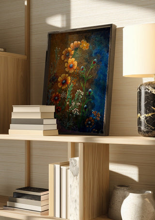 Cosmos in Ochre by Svetla Stoyanova Bassi in a dark frame on a wooden shelf beside books and a lamp