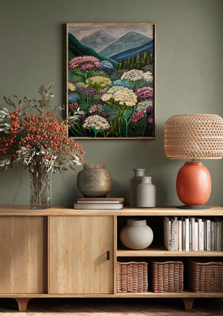 Mountain Meadow by Svetla Stoyanova Bassi above a wooden sideboard on a sage green wall