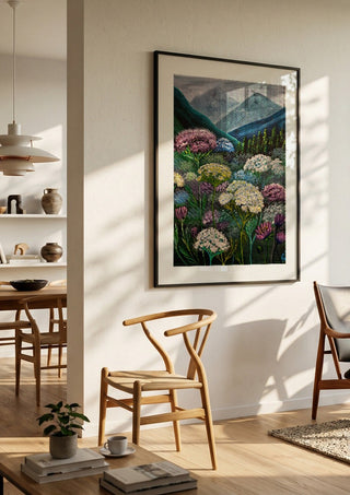 Mountain Meadow by Svetla Stoyanova Bassi in a black frame in a bright dining room with wooden chairs