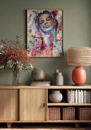 Sehnsucht by Anke Fillies above a wooden sideboard on a sage green wall