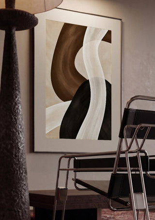 Dune and Shadow by Martina Karlsson framed in a dim room beside a tubular steel chair