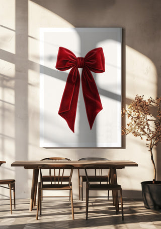 Red velvet bow by Ohkimiko hanging above a wooden dining table in warm sunlight
