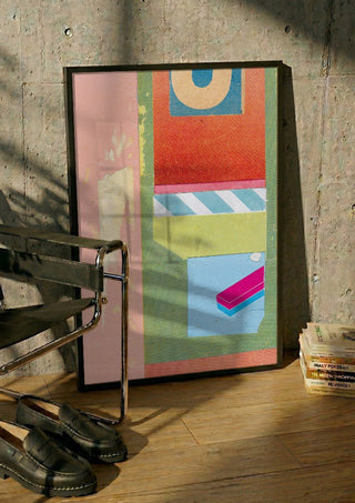 Bubble Gum by Kareem Rizk in a black frame leaning against a concrete wall by a steel chair