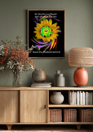Be like the sunflower by Walter Zettl above a wooden sideboard on a sage green wall