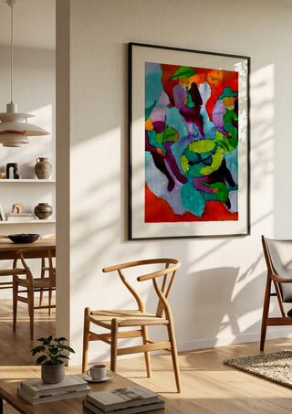 Mariachis by Nittaart in a black frame in a bright dining room with wooden chairs