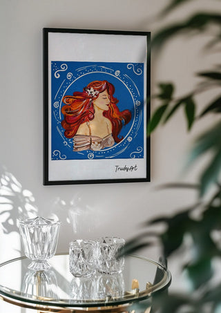 Luna in Blüte by Trude in a black frame above a glass table with crystal glassware