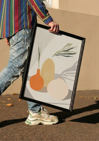 Vases 2 by ThingDesign carried in a black frame along a sunny street