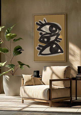 Abstract line art eyes 10 by ThingDesign framed above a beige armchair beside a potted plant