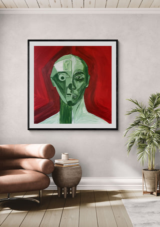 Green portrait / red field by Linor Citaku in a black frame above a leather armchair beside a palm