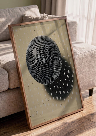Disco Star by Carl Smith ART in a walnut frame leaning against a grey sofa