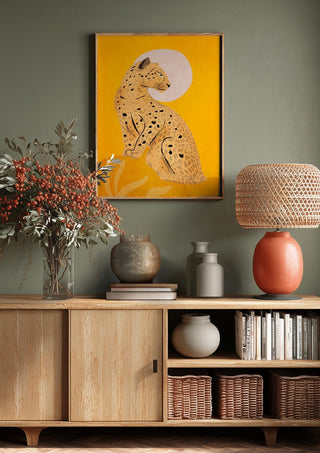 Leopard by ThingDesign above a wooden sideboard on a sage green wall