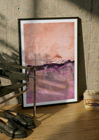 expressive landscape by Iris Lehnhardt in a black frame leaning against a concrete wall by a steel chair
