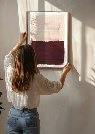 colorfields pale pink warm red by Iris Lehnhardt being hung on a sunlit wall